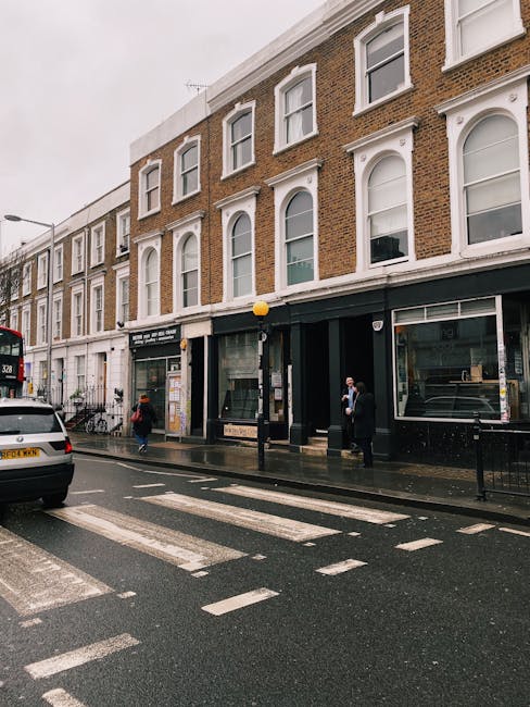 A rectangular white street sign mounted on a brick wall displaying the text 'WELCOME TO SOUTH KENSINGTON SW7' in black and red lettering. The sign is positioned at eye level, with a smooth finish and